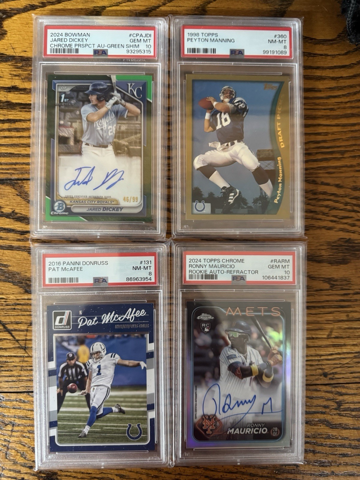 2 boxes of baseball, basketball, and football toploaders. With a stack of slabs