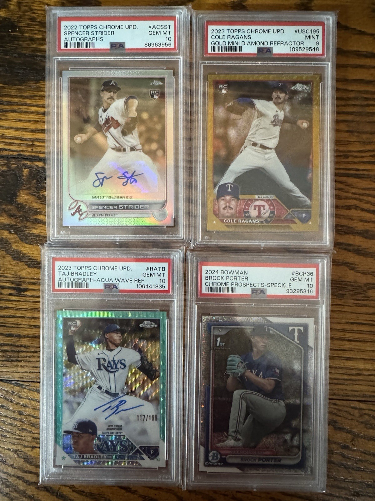 2 boxes of baseball, basketball, and football toploaders. With a stack of slabs