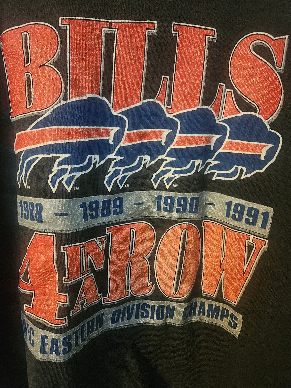 This vintage 1991 NFL Trench brand sweatshirt features a “Bills 4 in a Row”…