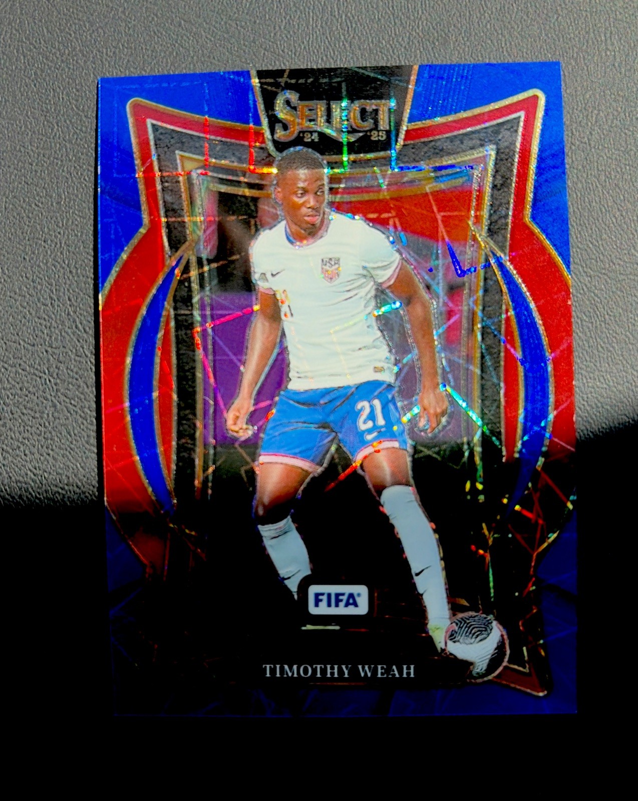 2024-25 Panini Select Fifa – Terrace Timothy Weah #99 USA Blue Lazer Prizm