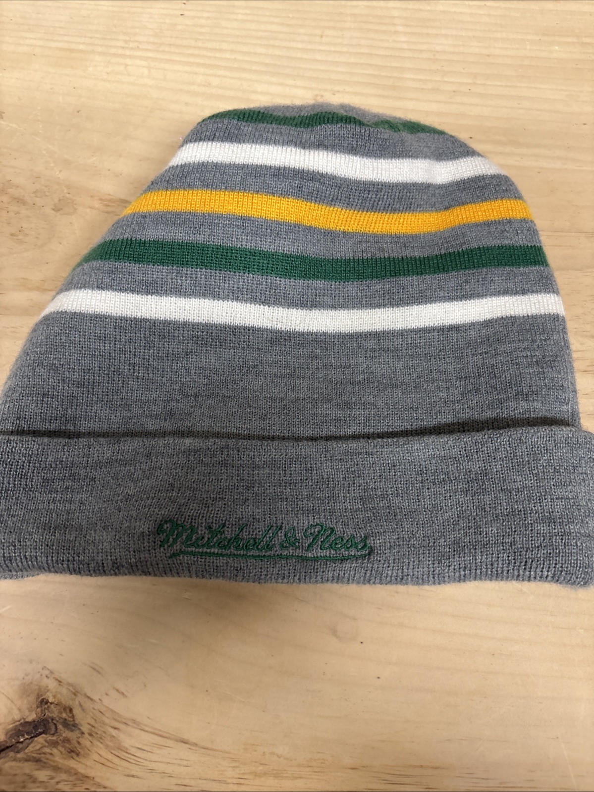 New Era Boston Celtics knit beanie striped bands of green, white, and yellow.