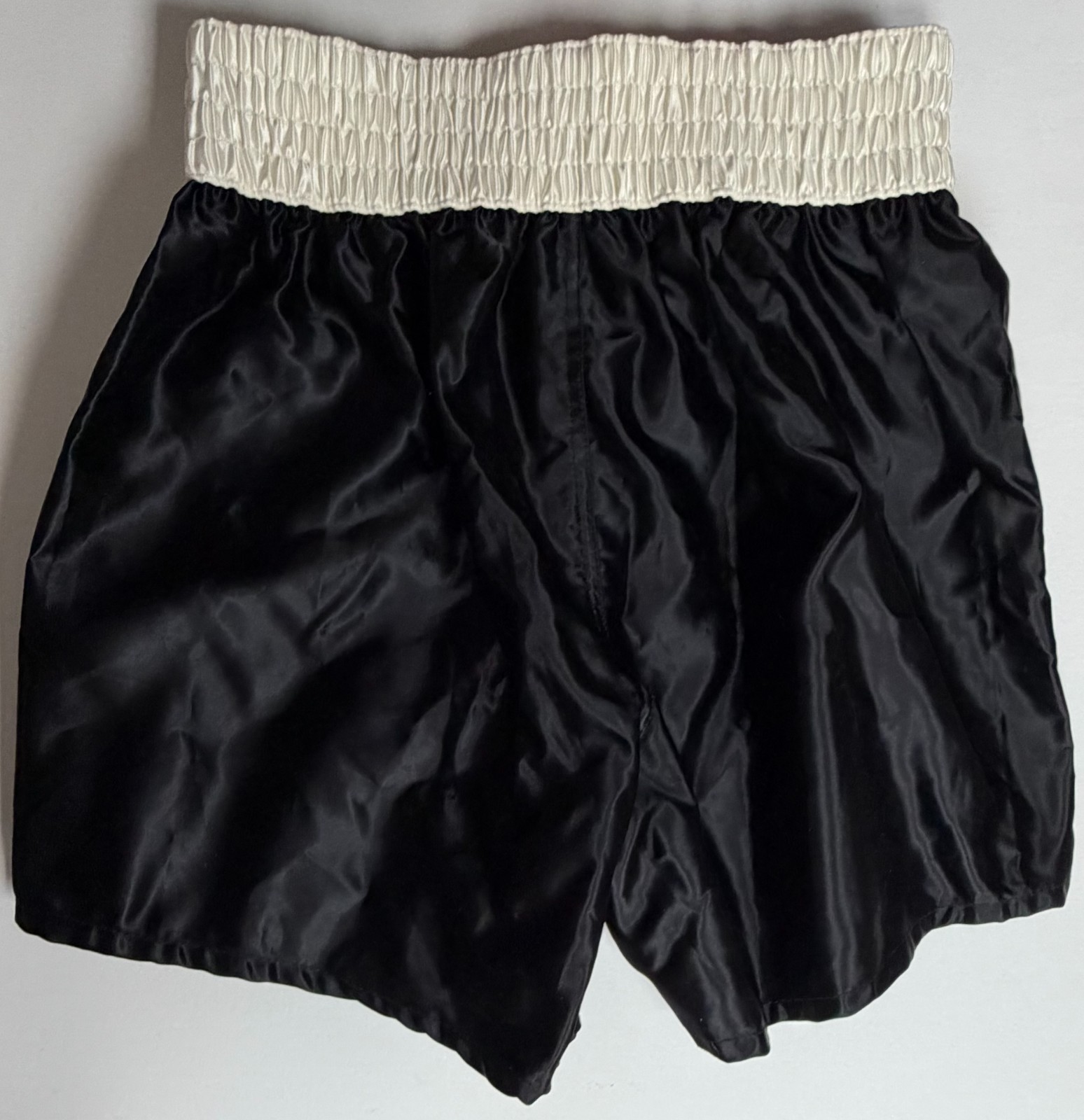 RARE MUHAMMAD ALI SIGNED AND INSCRIBED “KING OF BOXING” BLACK BOXING TRUNKS JSA!